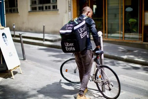 Paris/France - July 2019: Uber eats bike deliver at the Paris city streets Stock Photos