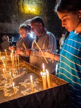 Parishioners light candles in Sevanavank monastery Stock Photos