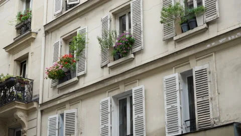 Parisian apartment building facade features windows with open wooden shutters Stock Footage 337294937