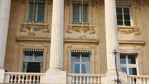 Parisian building facade with classical columns and windows Photos