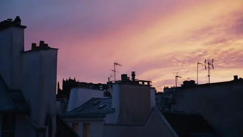 Parisian rooftops silhouette against dramatic sunset sky Stock Footage 346990261