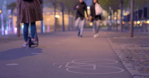 In the park are ride on roller skates and on a scooter and on a skateboard Stock Footage 119567247