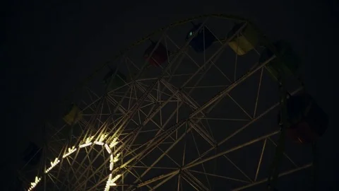 Park attraction ferris wheel carousel swing Night evening with illuminated light Stock Footage 70033188
