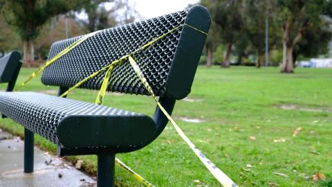 Park Bench With Caution Tape Foto stock