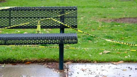 Park Bench With Caution Tape Foto stock