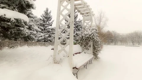 Park bench covered with snow Video stock 79799075
