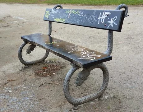 Park bench with graffiti Stock Photos