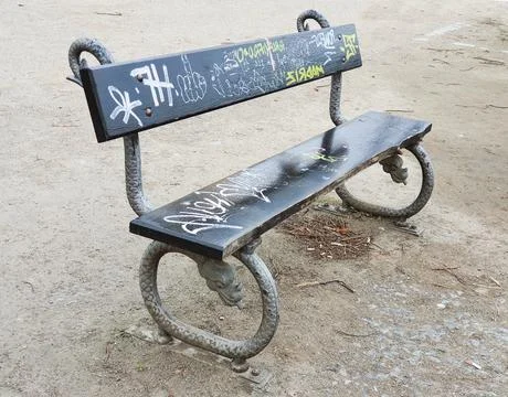 Park bench with graffiti Stock Photos