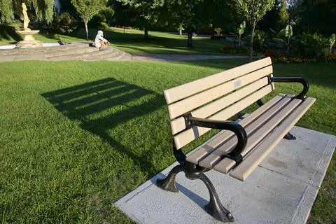 Park bench with light and shadow in the public park Stock Photos