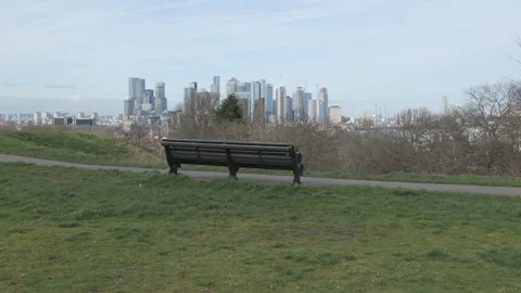 A park bench overlooking a modern city skyline. Stock Footage 296197451