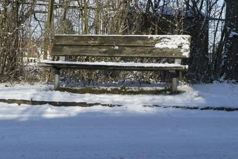 Park bench in snow Stock Photos