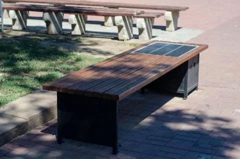 Park bench with solar panel. Stock Photos
