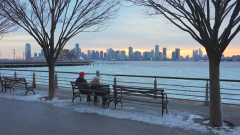 Park benches placed Hudson River Park along frozen Hudson River in New York City 動画素材 302321865