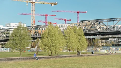 Park in Berlin during Coronavirus Lockdown, U-Bahn passing over a bridge Stock Footage 130138610
