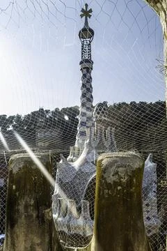 Park Güell Viewed Through Mesh with Sunlight Filtering In Stock Photos