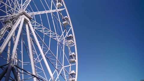 In the park, a large Ferris wheel is spinning slowly. High-altitude view wheel Stock Footage 139979679