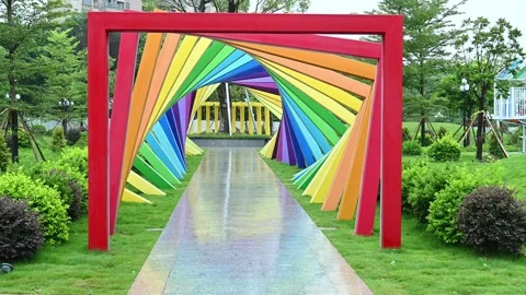 Park with multicolor metal frames in a rainy and windy day at horizontal Stock Footage 313427207