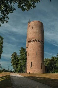 Park with path and brick tower at Bruges Stock Photos