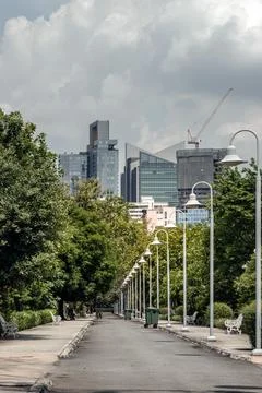 A park path with a concrete border. Row of lantern light lamps, Cast iron b.. Stock-Fotos