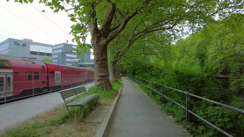 Park path next to railway with Google office building in Zurich Stock Footage 334631136