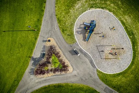 Park with a playground and a triangular flower bed 스톡 사진