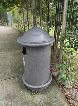 Park Trash Bin on Concrete Path Stock Photos