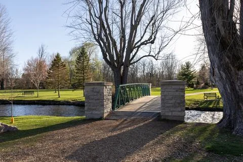 Park view in spring with a bridge over stream. Stewart Park In Perth, Ontario Stock Photos