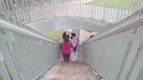 Park visitors walking down the stairs at the Christina Martha Tiahahu park Stock Footage 221979772