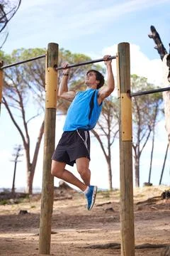 Park, workout and man on pull up bar with training for morning exercise Stock Photos