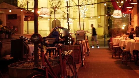 Parked bicycle in restaurant at night Video stock 74356879