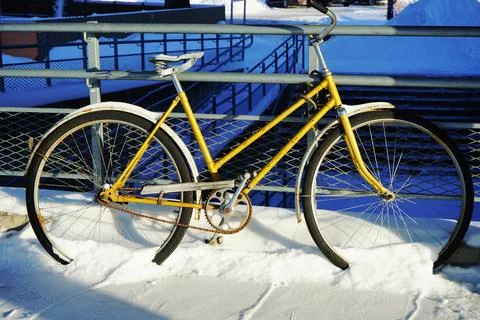 Parked bicycle in the snow Stock Photos