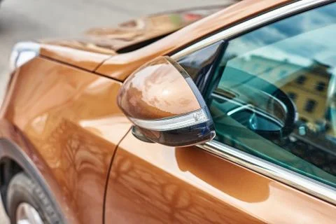 Parked car with automatic folding rear view side mirror Stock Photos