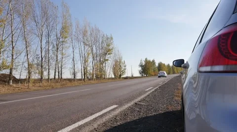 Parked car on the side of the highway and near passing car Stock Footage 56531246