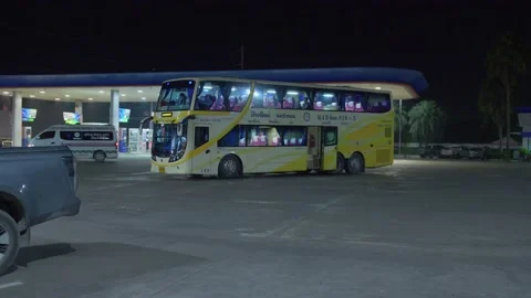 A parked double-decker passenger bus near a gasoline station in Udon Video stock 231430310