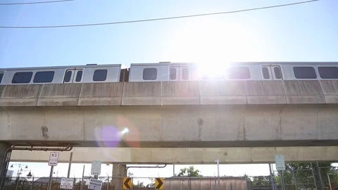 Parked Elevated Train Pull Back to Reveal Sun Lens Flare Stock-Footage 101652771