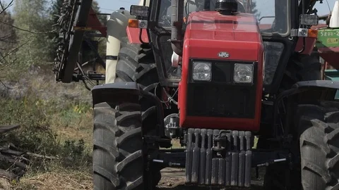 Parked red tractor in the yard. front view of hood with wheels Stock Footage 122758733
