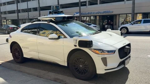 A parked Waymo self driving car awaits it's pickup Video stock 337579410