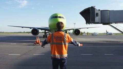 Parking airplane. Aircraft traffic controller at the airport Stock Footage 78358550