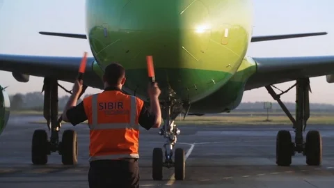 Parking airplane. Aircraft traffic controller at the airport Stock Footage 78359209