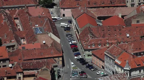 Parking and roundabout traffic in old European town with red rooftops Stock Footage 40532443