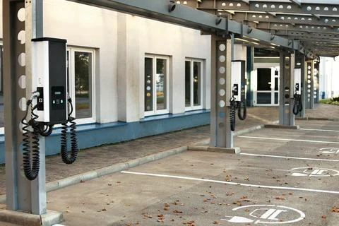 Parking area with multiple charging stations for electric vehicles. Clean e.. Stock Photos
