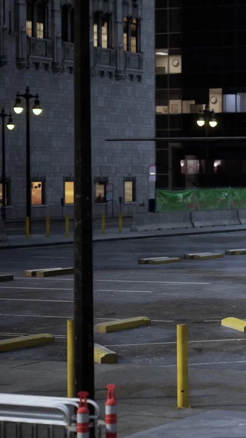 Parking lot with empty spaces at night near buildings in city Stock-Footage 338425825
