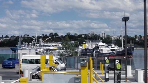 Parking Lot Entry and Waterfront Activity at Sydney Harbor with Boats and Cars Stock Footage 345742079