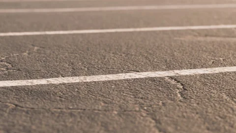 Parking lot surface shows cracks and lines in a commercial area Stock-Footage 339504054
