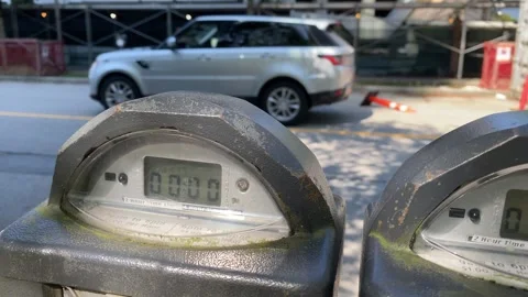 Parking Meter with background of Construction cones and Cars Driving Stock Footage 281058706