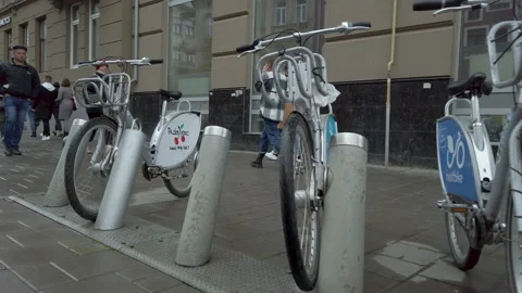 Parking of rental bicycles at street. Using eco transport. Bicycle-sharing syste Видео 144282902
