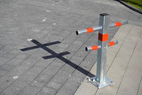 Parking Restriction Posts. Close-up of gray and red steel bollards that restr Stock Photos