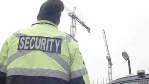 Parking security watching over parking lot and construction site Stock Footage 237634594
