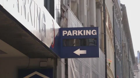 Parking signboard with arrow pointer above entry on a building facade in city ce Stock Footage 289320479