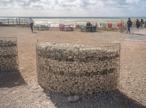 Parking space for disabled driver built from beach pebbles Basket holding ... Stock Photos